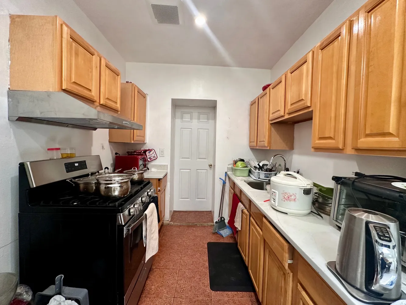 a kitchen with a stove a sink and a refrigerator