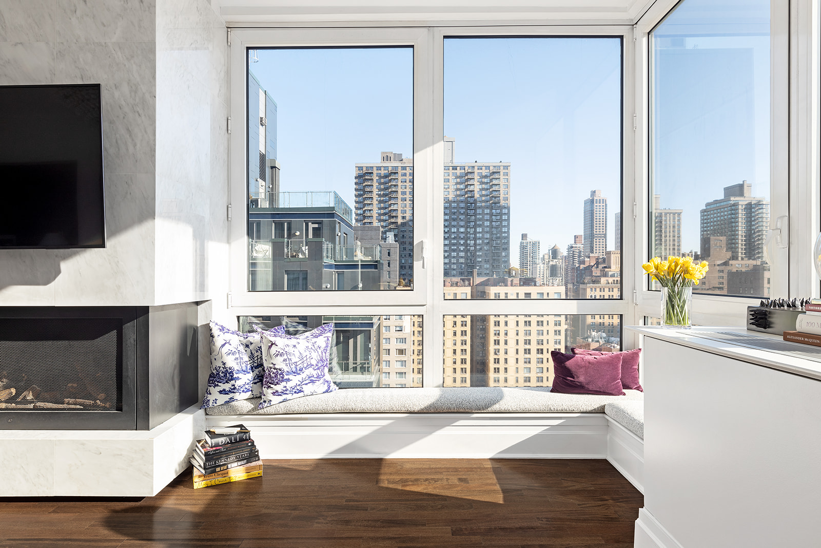 300 East 77th Street, Unit 18C Manhattan, NY 10075 - Photo 5 of 12 a living room with a fireplace furniture and a flat screen tv