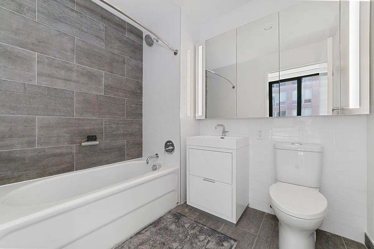 42-14 Crescent Street, Unit 9D Queens, NY 11101 - Photo 5 of 6 a bathroom with a toilet sink and bathtub