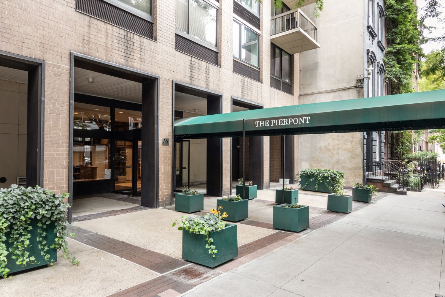 111 East 30th Street, Unit 14A Manhattan, NY 10016 - Photo 14 of 16 a front view of a building with a garden and plants