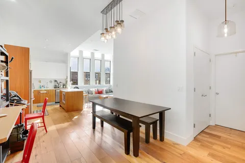 a living room with dining room and wooden floor