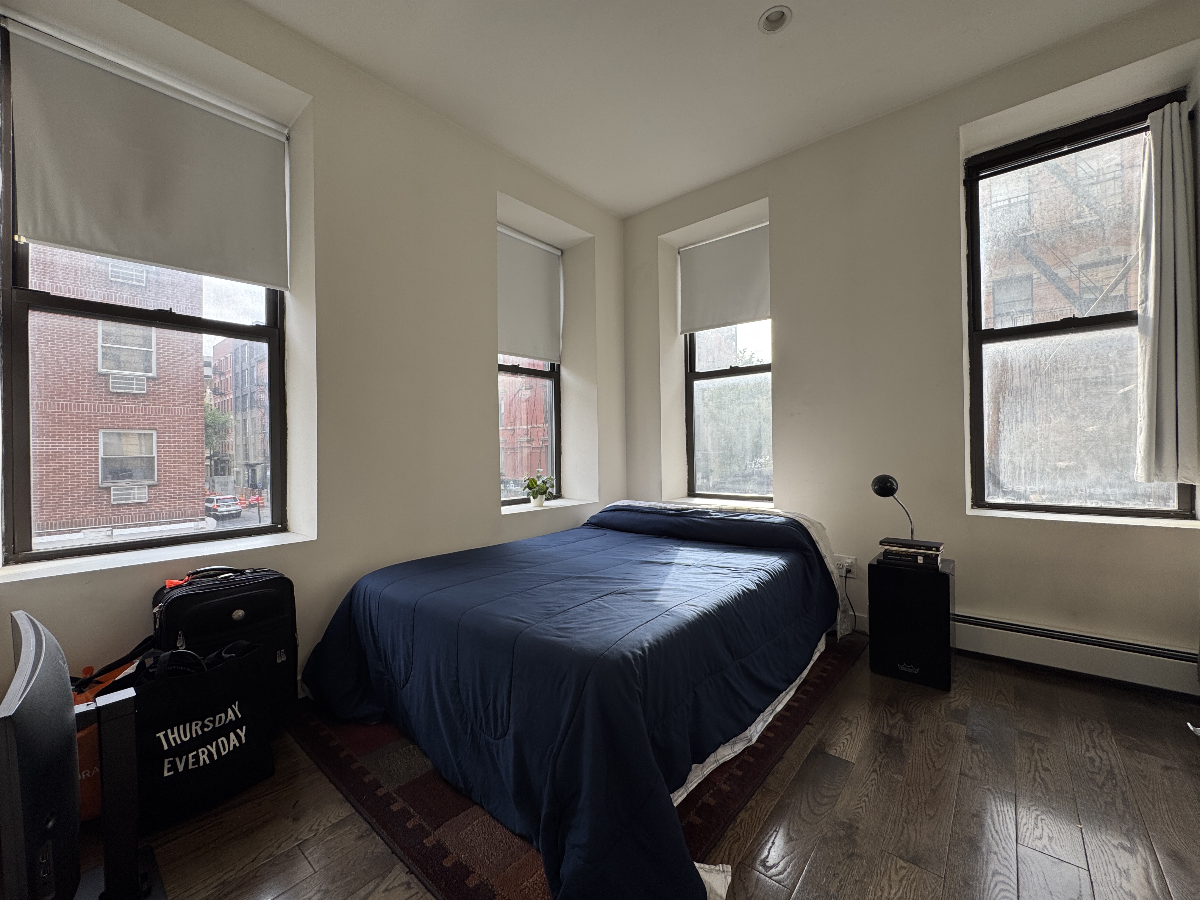 a bed sitting in a bedroom next to a window