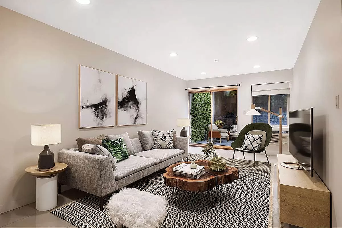 a living room with furniture a fireplace and a large window
