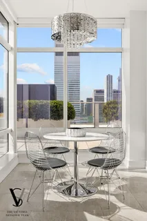 a living room filled with furniture and a chandelier