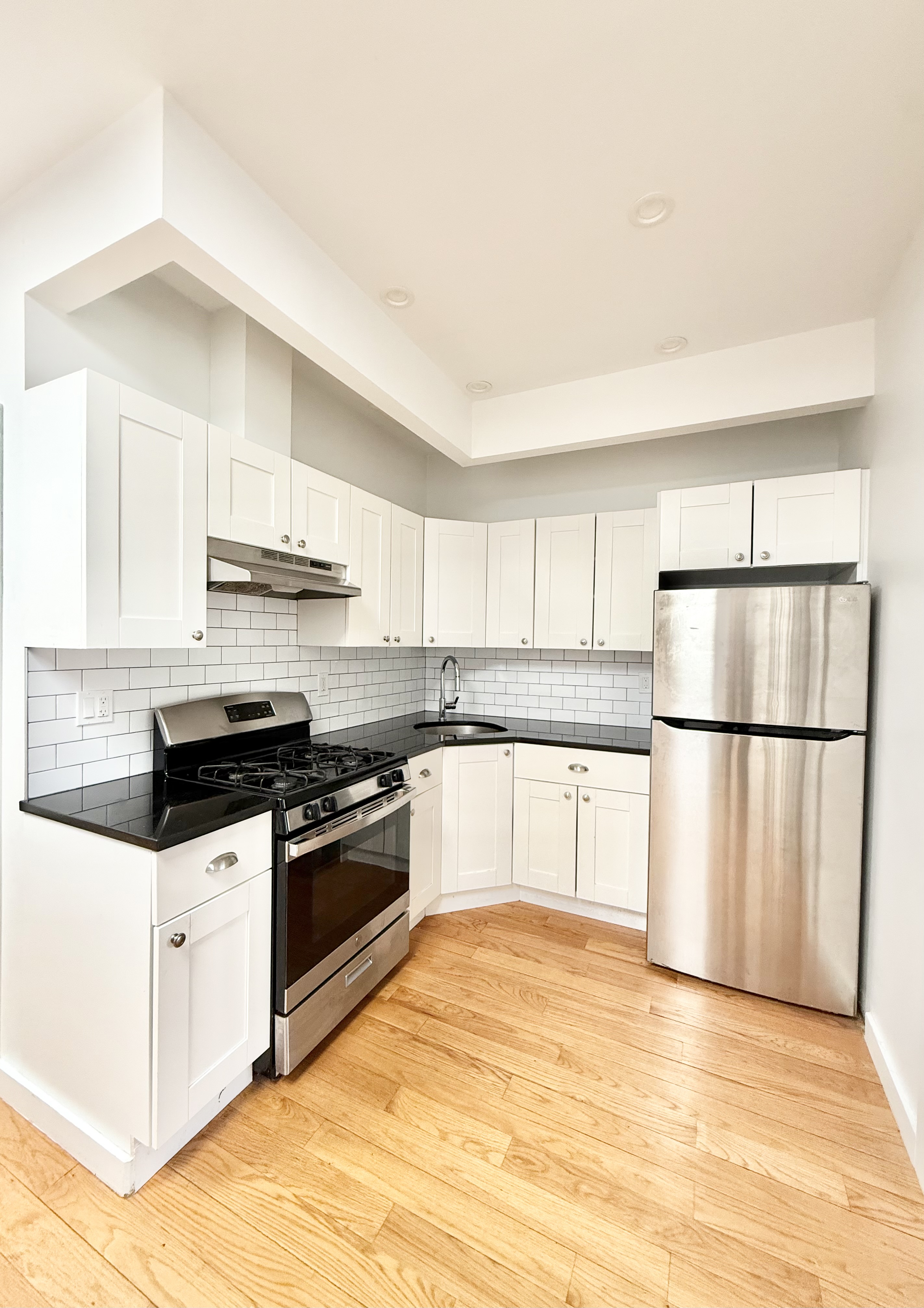 2013 Flatbush Avenue, Unit 2R Brooklyn, NY 11234 - Photo 2 of 11 a kitchen with stainless steel appliances granite countertop a refrigerator sink and white cabinets