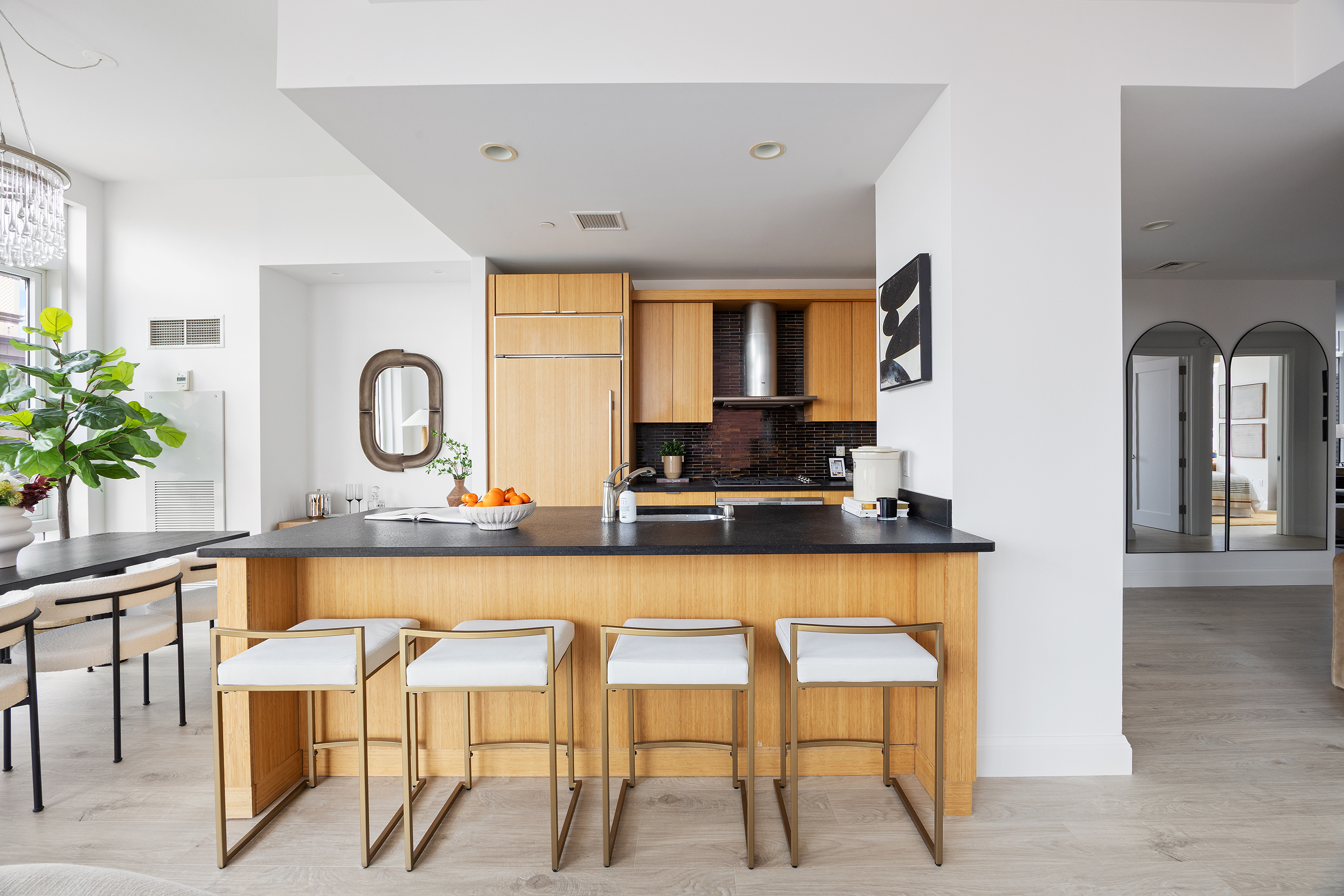 70 Little West Street, Unit 7L Manhattan, NY 10004 - Photo 2 of 25 a large living room with stainless steel appliances kitchen island granite countertop furniture and a large window