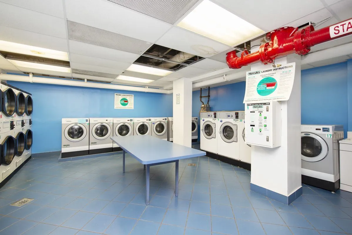 a utility room with stainless steel appliances and cabinets