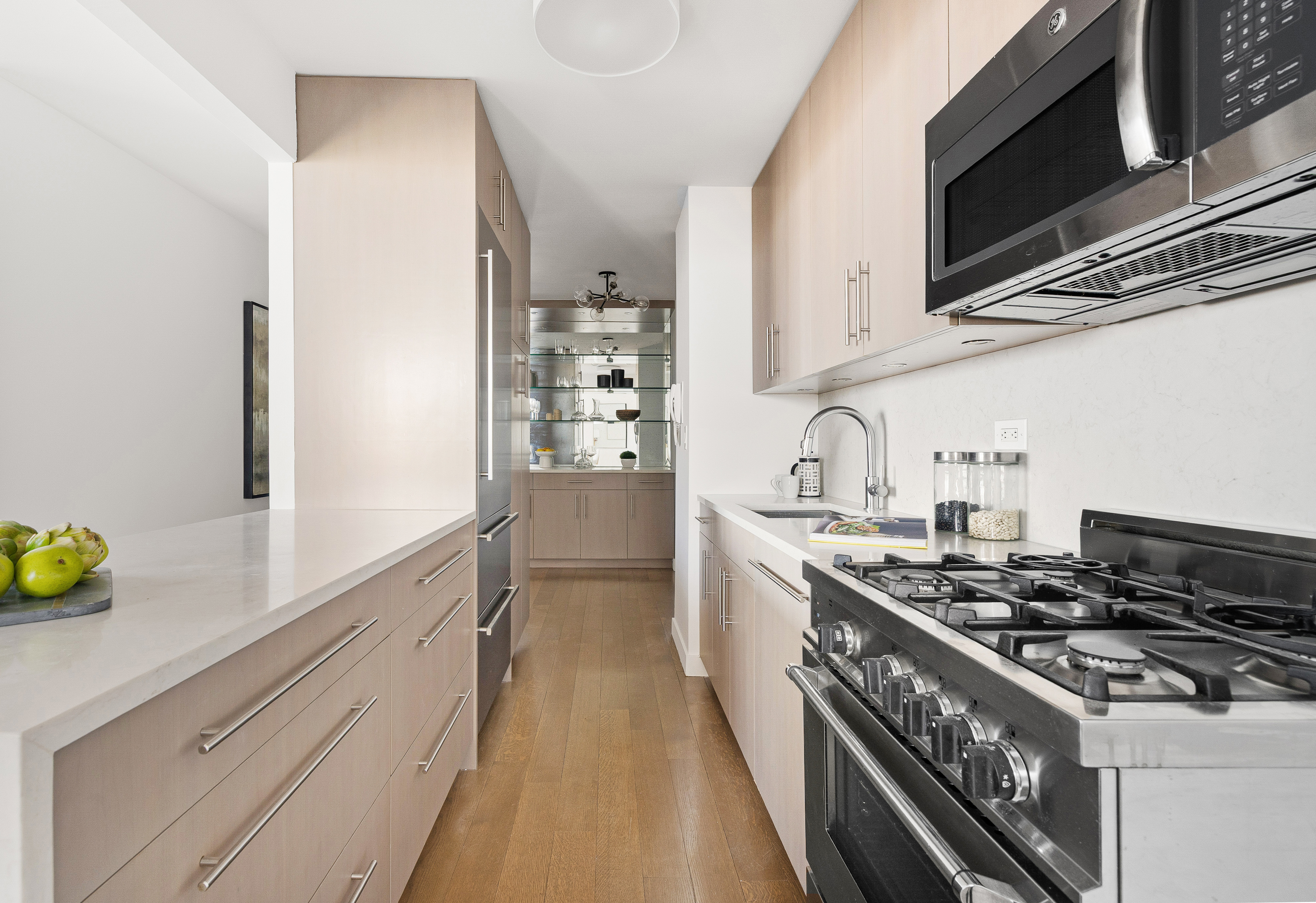 1623 3rd Avenue, Unit 36A Manhattan, NY 10128 - Photo 4 of 17 a kitchen with stainless steel appliances a stove a sink and a refrigerator
