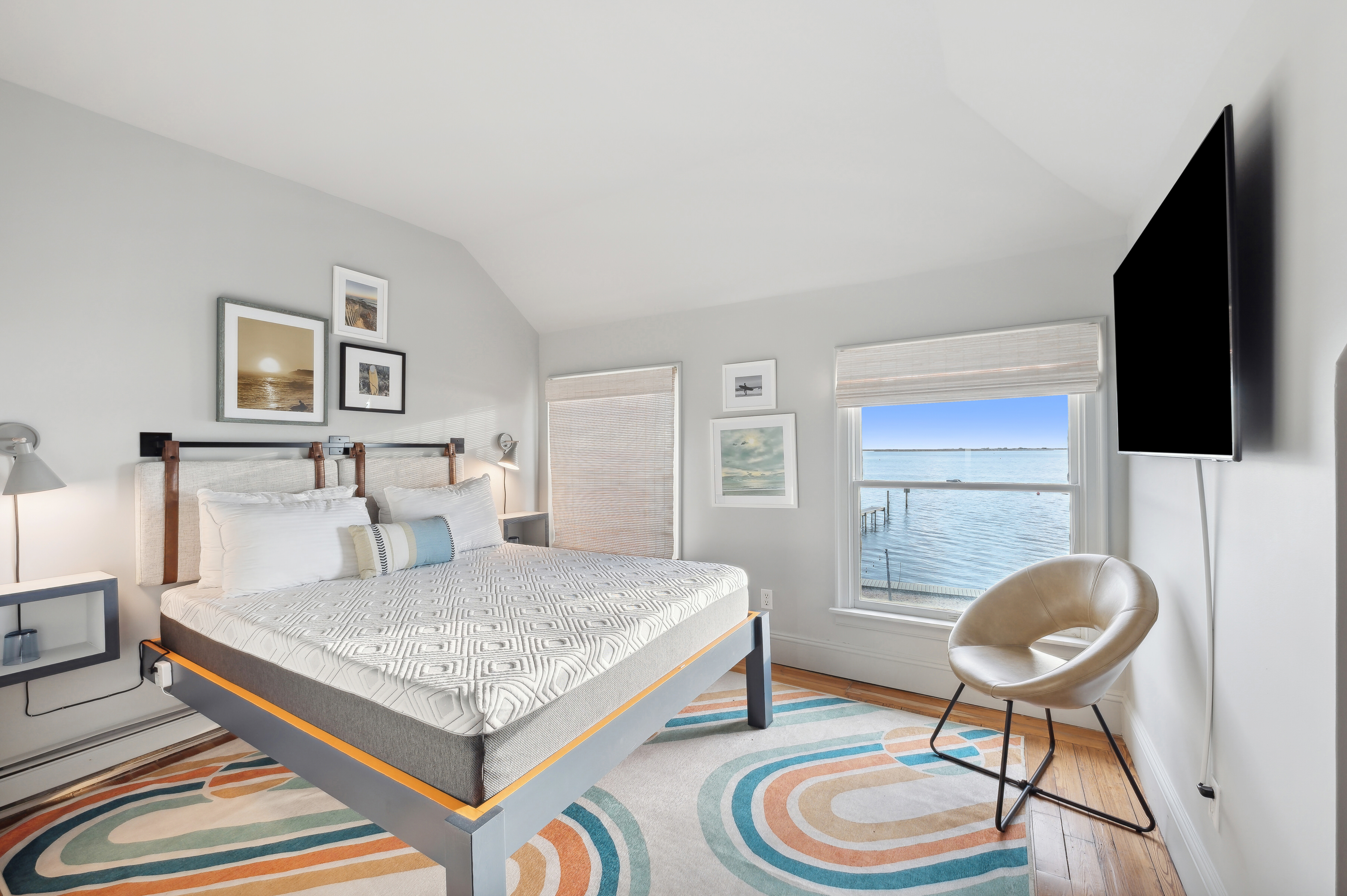 32 Lighthouse Road Hampton Bays, NY 11946 - Photo 24 of 51 a bedroom with a bed and a flat screen tv