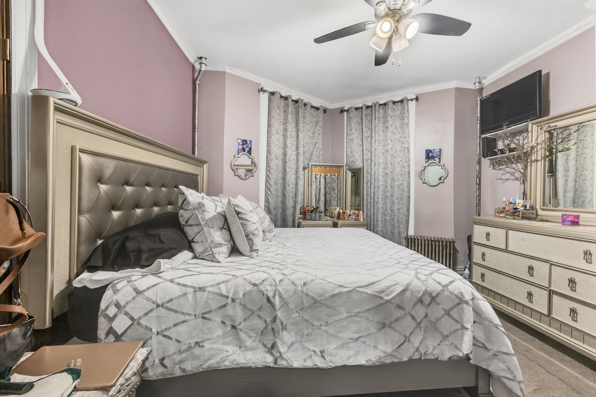 397 Douglass Street Brooklyn, NY 11217 - Photo 6 of 15 a bedroom with a large bed and a chandelier
