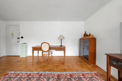 a dining room with table chairs and wooden floor