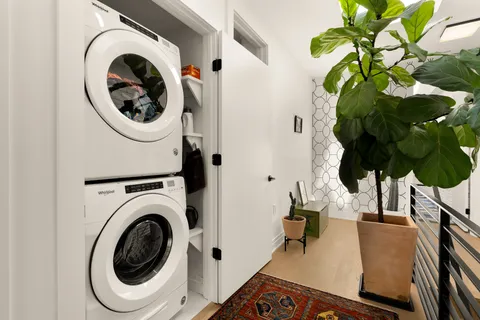 a view of a bedroom with washer and dryer