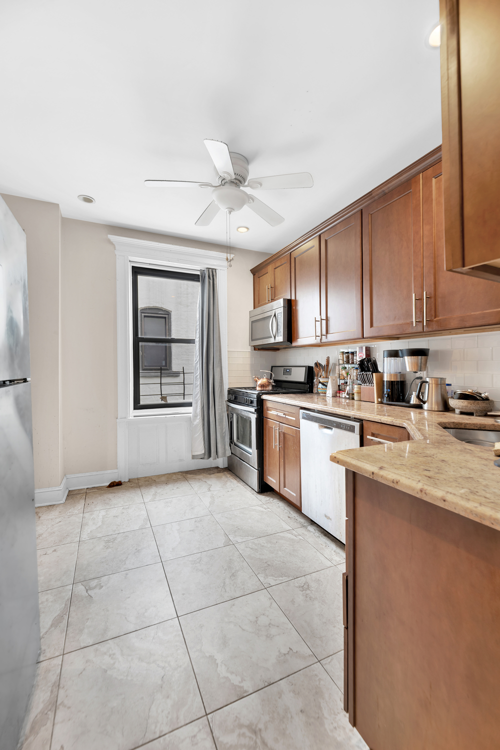 571 8th Street Brooklyn, NY 11215 - Photo 6 of 13 a kitchen with stainless steel appliances granite countertop a stove a sink and a refrigerator