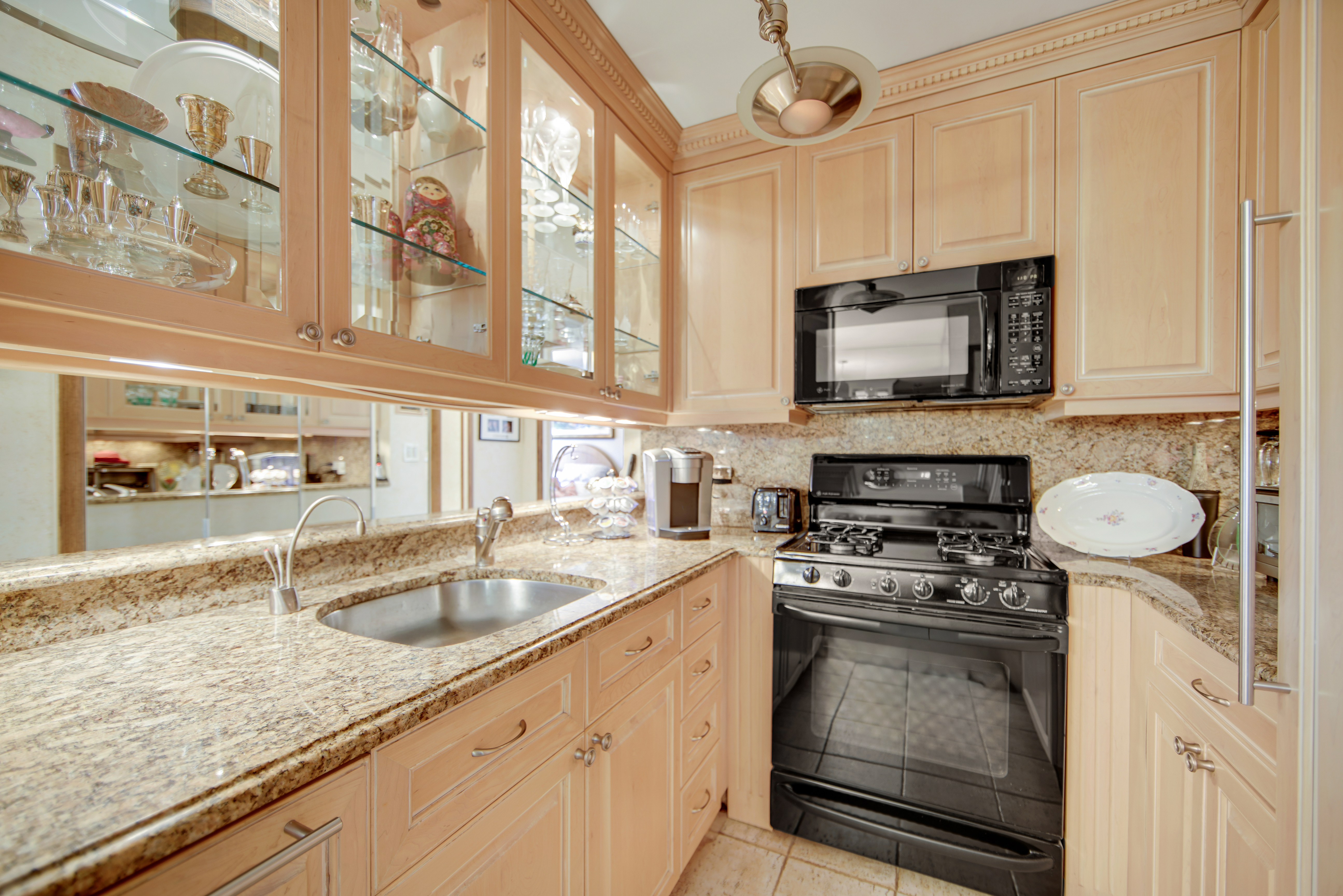 400 East 85th Street, Unit 15F Manhattan, NY 10028 - Photo 4 of 11 a kitchen with a sink stove and microwave