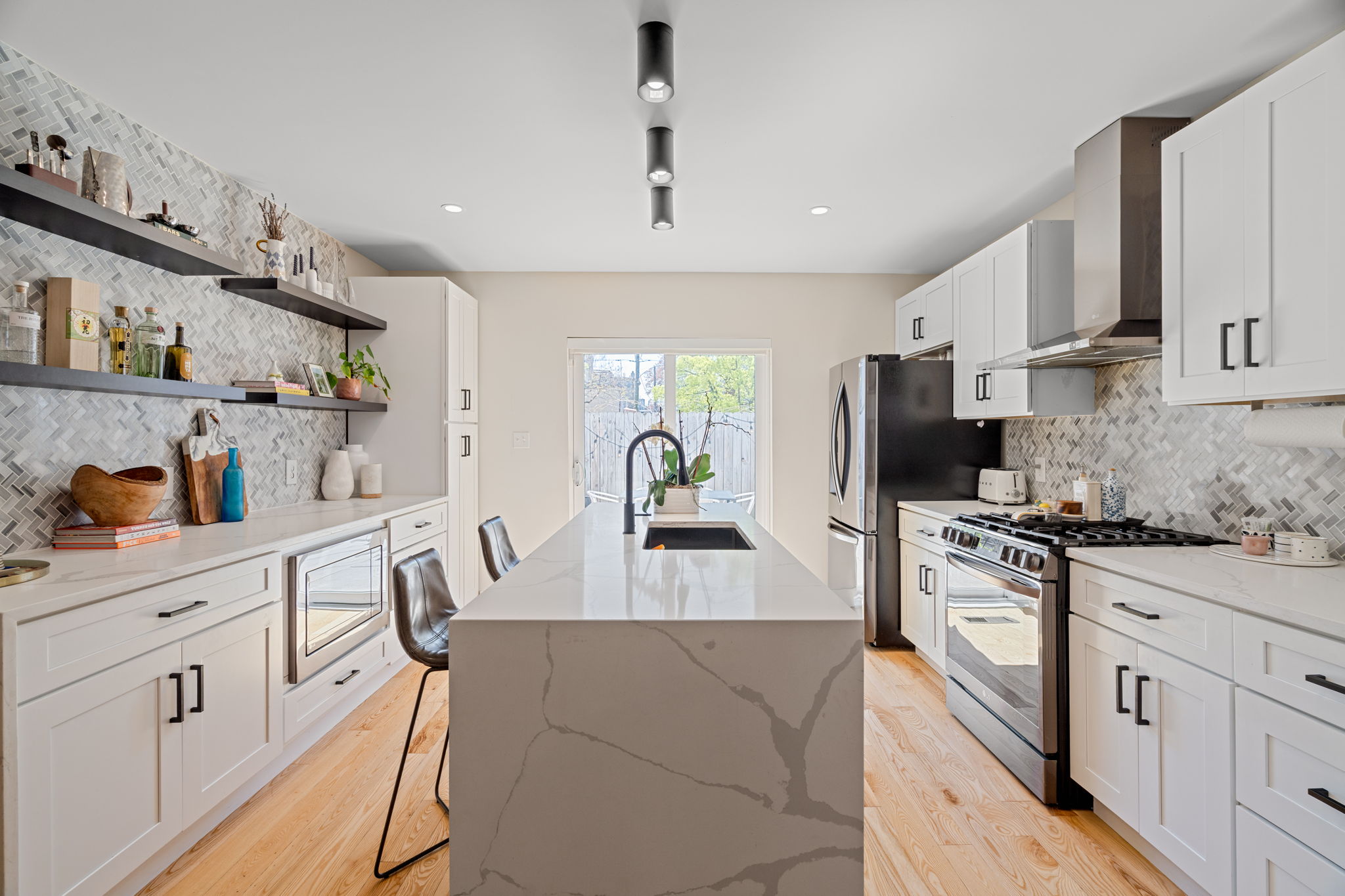 1934 Pemberton Street Philadelphia, PA 19146 - Photo 15 of 50 a kitchen with white cabinets and stainless steel appliances