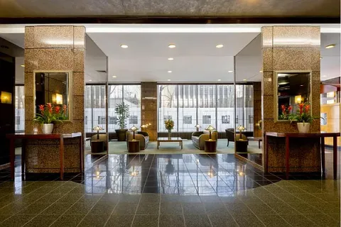 a living room with lots of furniture and large windows