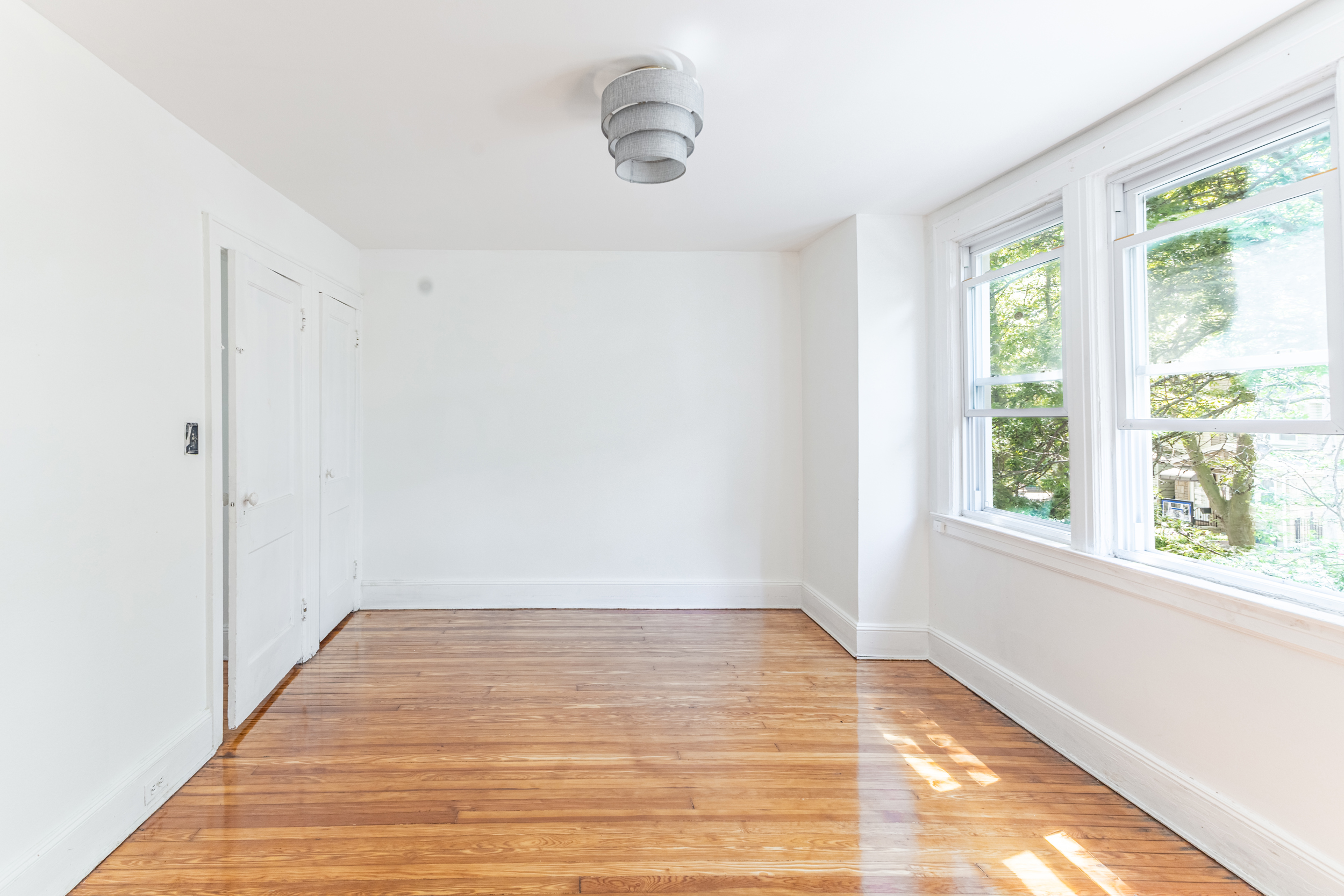69-29 67th Place Queens, NY 11385 - Photo 18 of 24 a view of empty room with wooden floor and fan