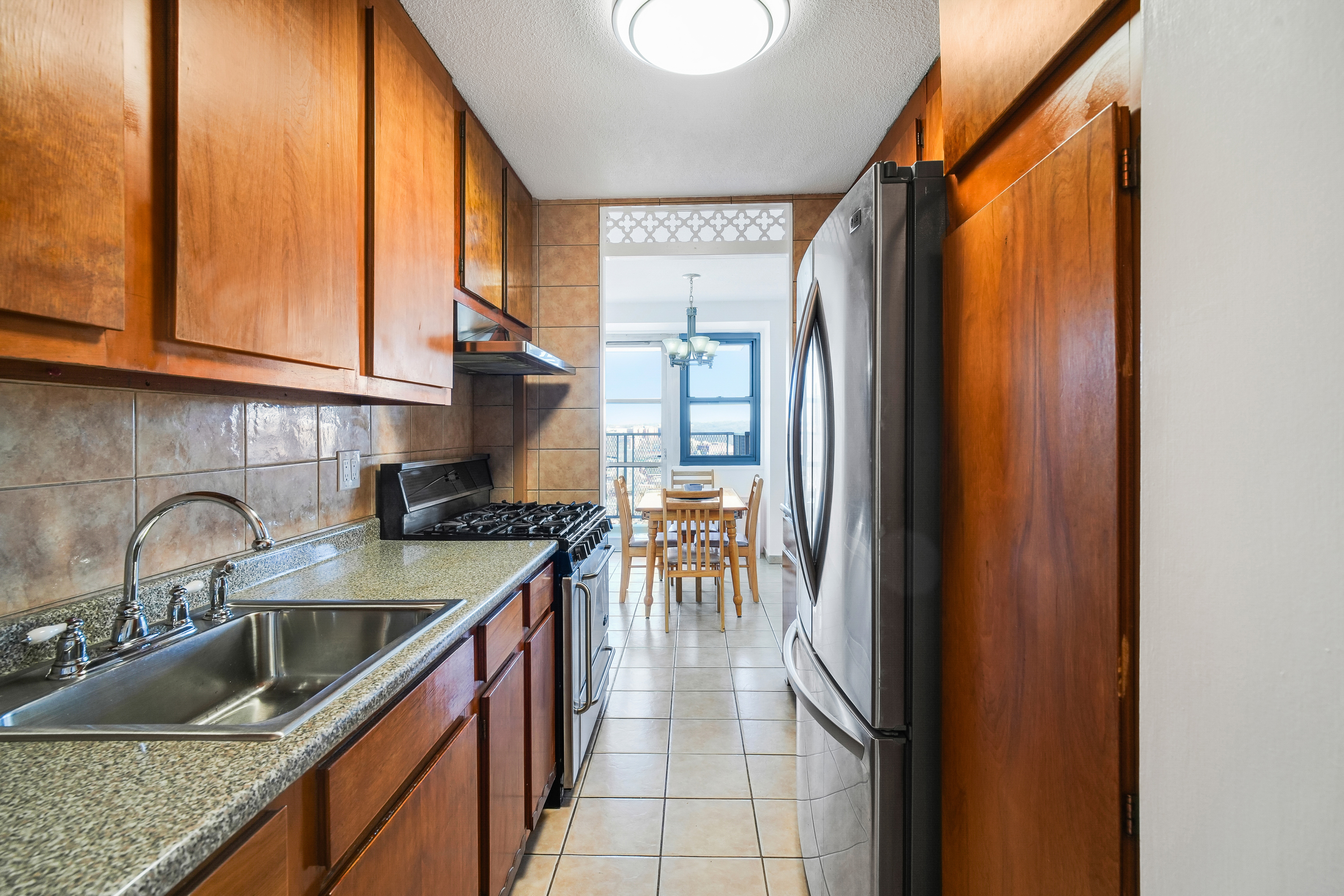 290 West 232nd Street, Unit 18B Bronx, NY 10463 - Photo 5 of 16 a kitchen with a sink a stove and cabinets