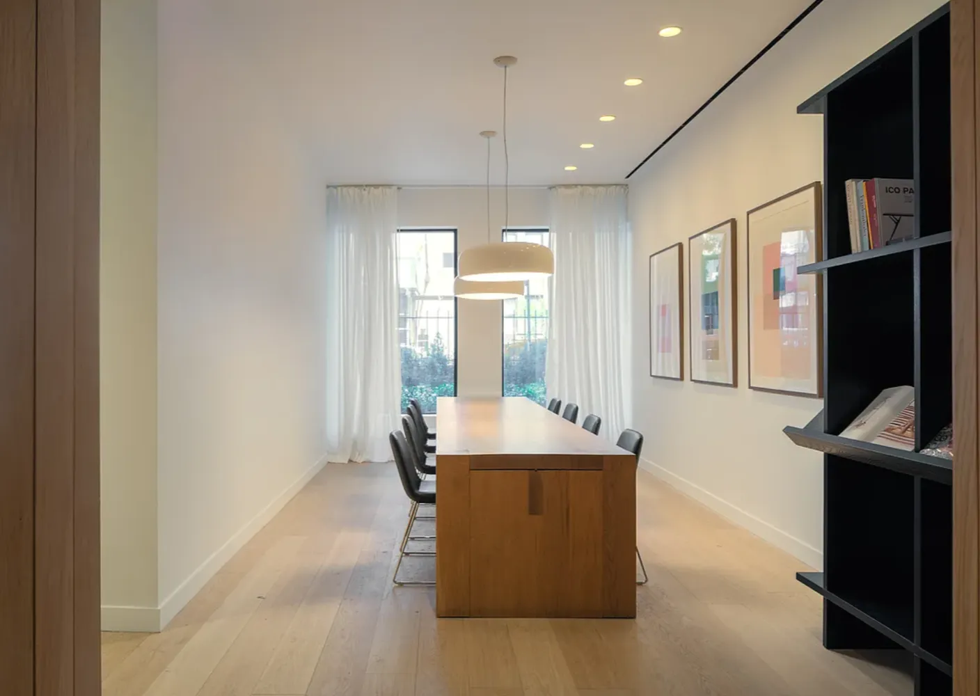 a room with table chairs and flat screen tv