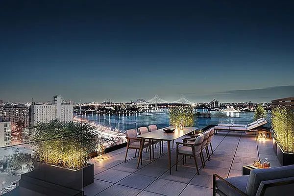 a terrace with outdoor seating and city view