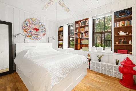 a spacious bedroom with a bed and a window