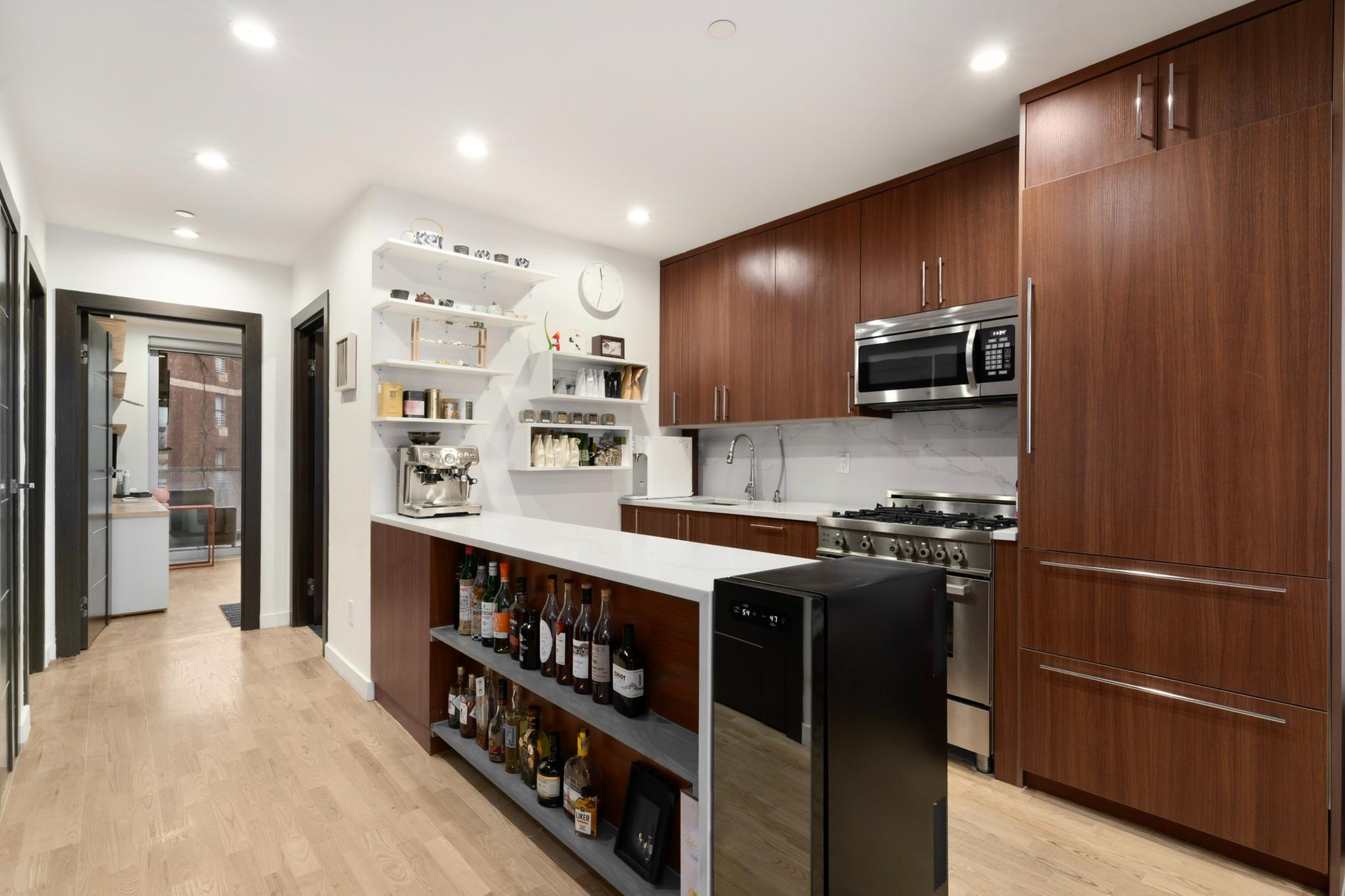 261 Union Avenue, Unit 4 Brooklyn, NY 11211 - Photo 3 of 13 a kitchen with stainless steel appliances granite countertop a refrigerator a stove and a sink with wooden cabinets