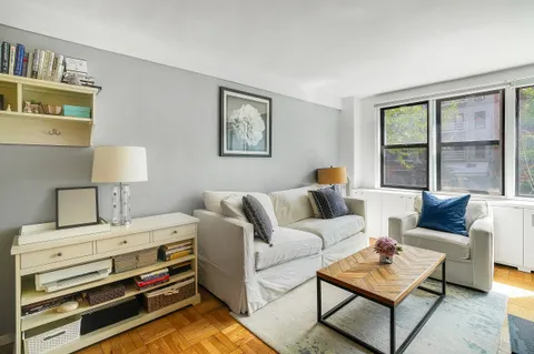 a living room with furniture and a lamp