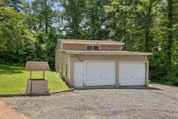 a side view of a house with a yard and garage