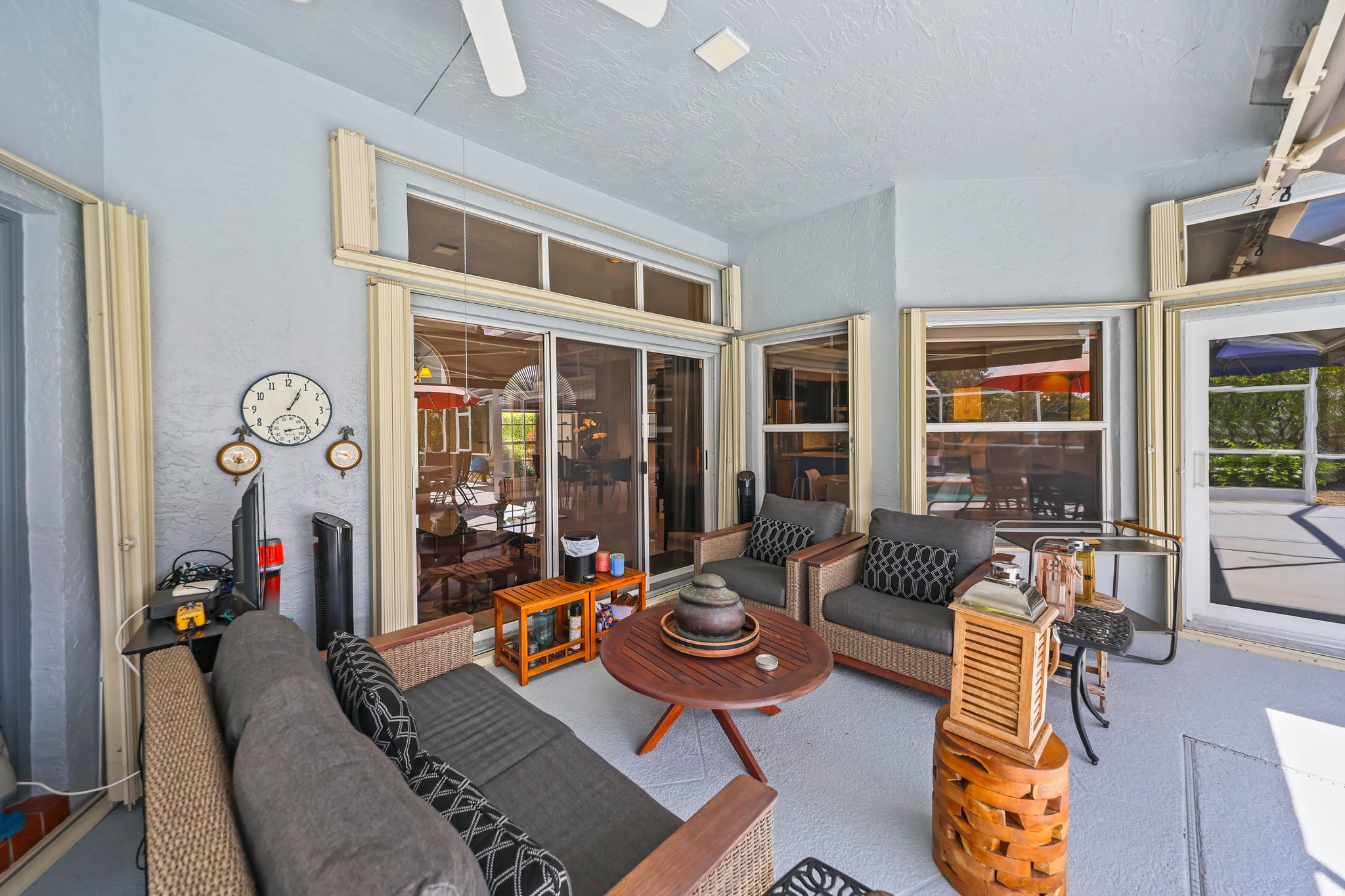 20317 Hacienda Court Boca Raton, FL 33498 - Photo 50 of 100 a living room with furniture and floor to ceiling windows