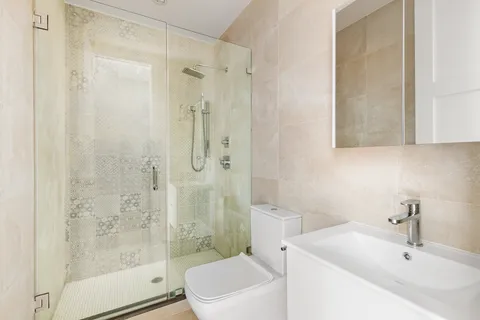 a bathroom with a sink toilet and shower