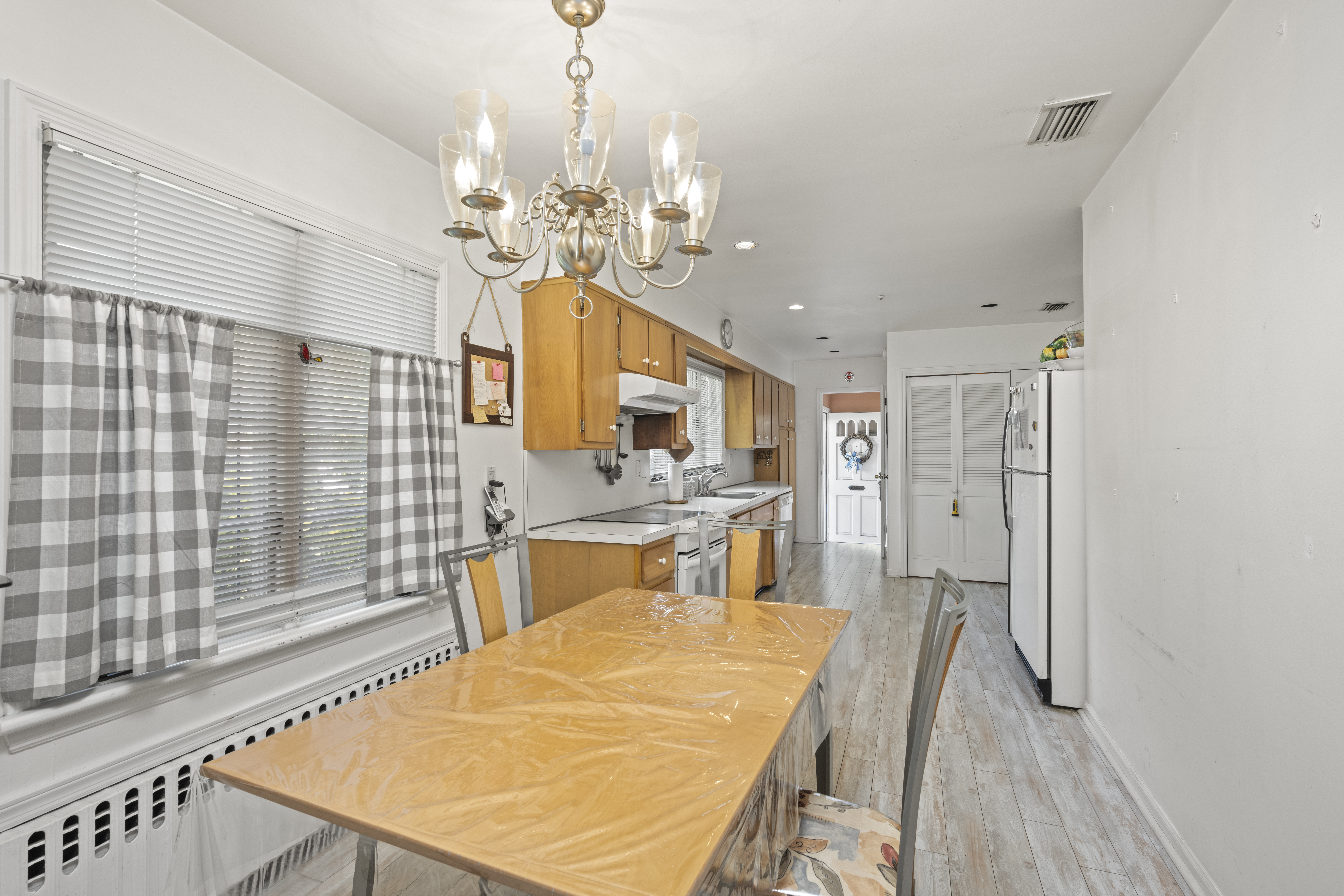 420 Ocean Terrace Staten Island, NY 10301 - Photo 10 of 28 a view of a dining room with furniture and a chandelier