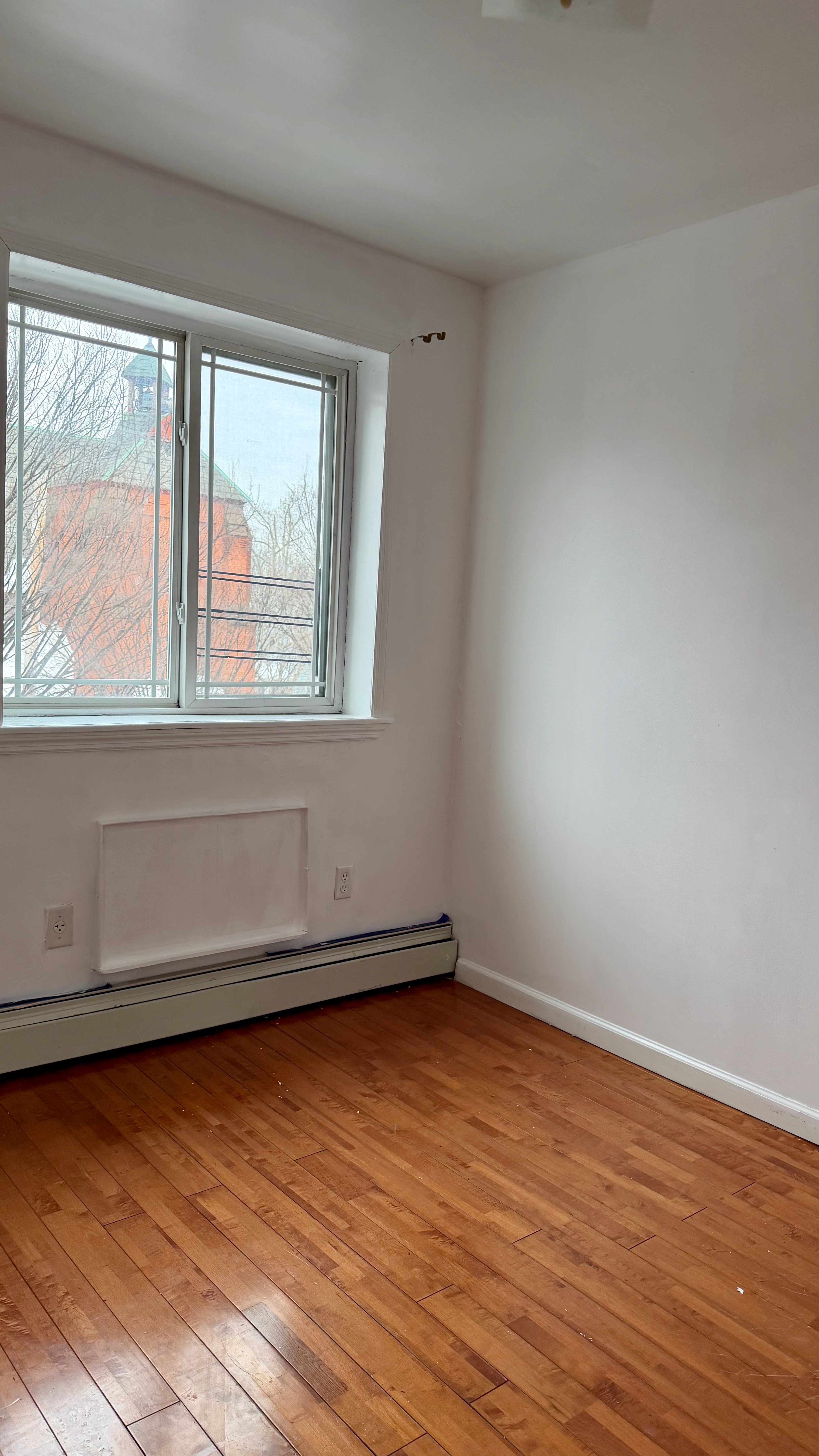 48 Schenck Avenue, Unit 3 Brooklyn, NY 11207 - Photo 3 of 7 wooden floor in an empty room with a window