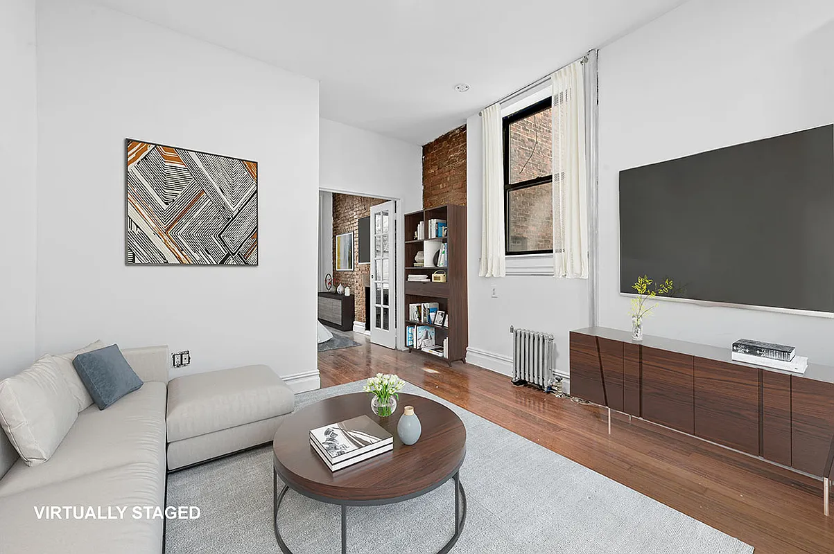 279 East Houston Street, Unit 1C Manhattan, NY 10002 - Photo 2 of 5 a living room with furniture and a flat screen tv