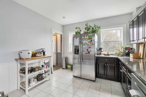 a kitchen with stainless steel appliances granite countertop a refrigerator and a sink