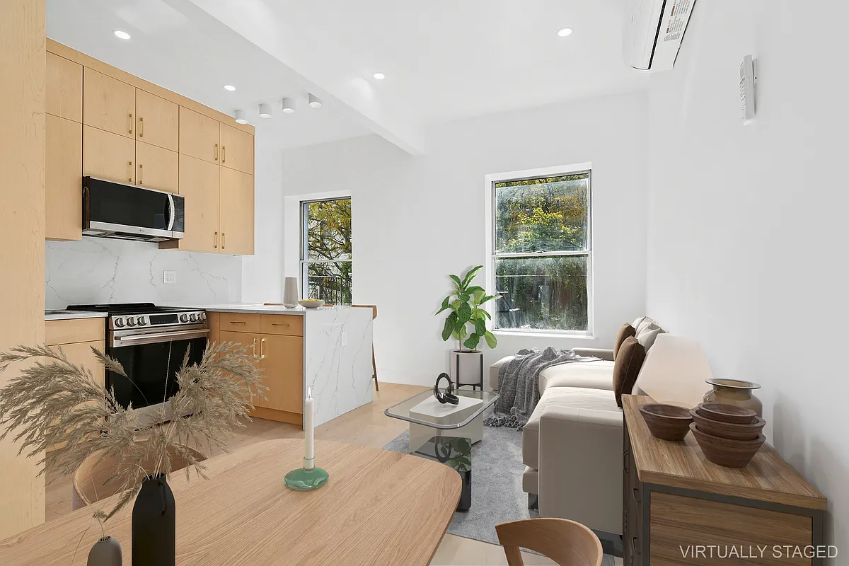 a living room with furniture a flat screen tv and a window