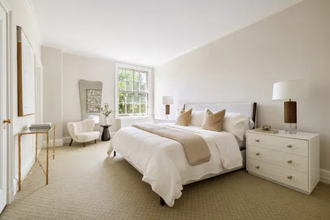 a bedroom with bed and window