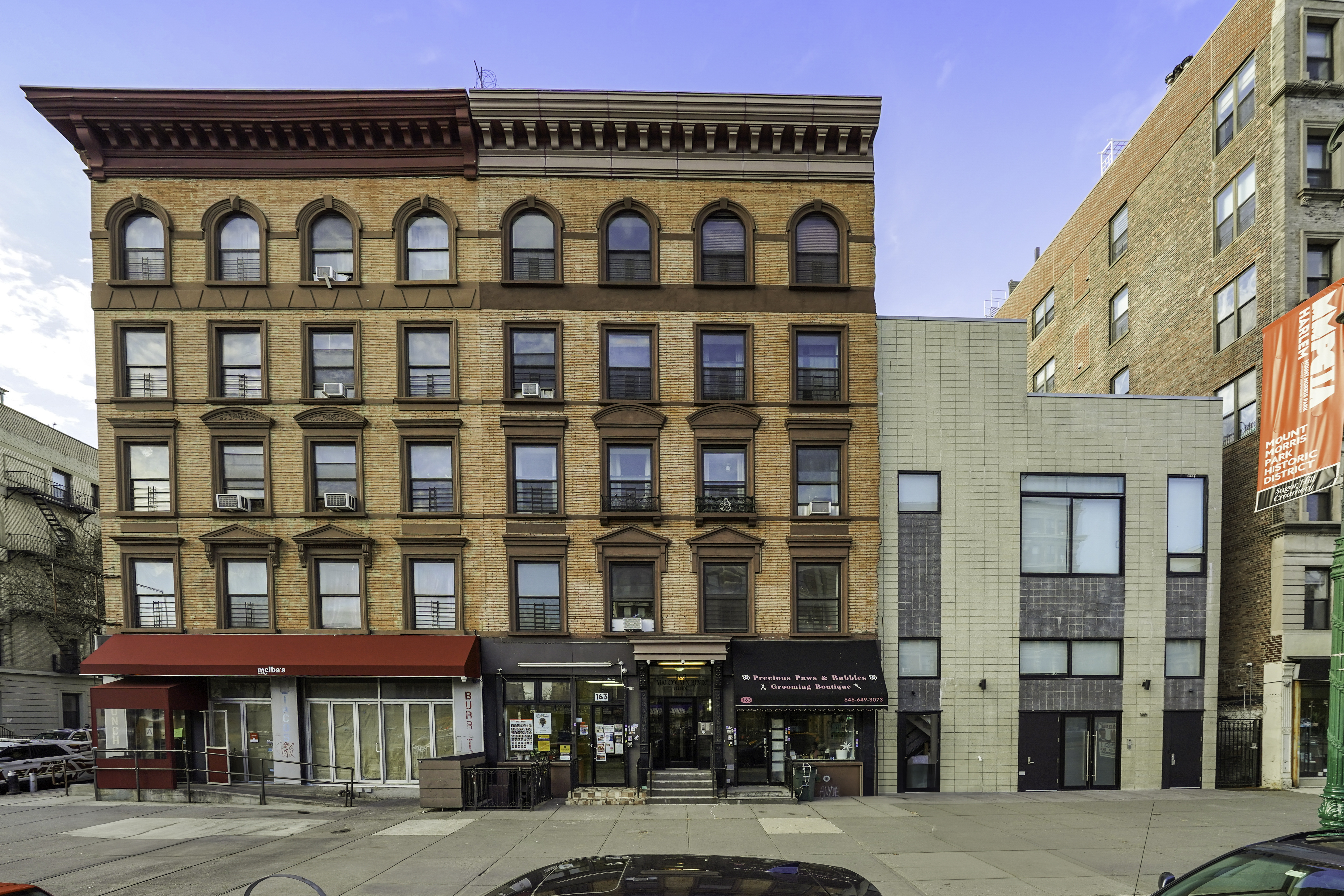 163 Lenox Avenue, Unit 5A Manhattan, NY 10026 - Photo 15 of 16 a view of a building with a lot of windows
