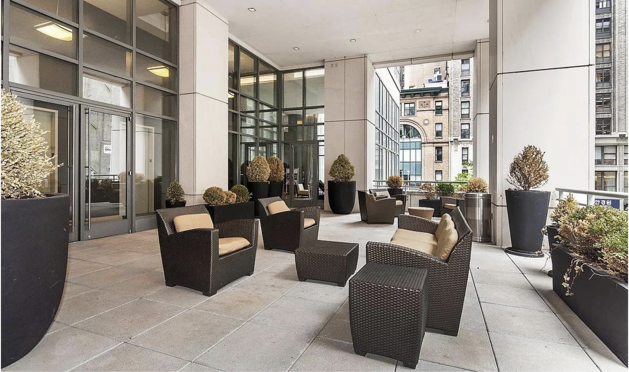325 5th Avenue, Unit 16C Manhattan, NY 10016 - Photo 22 of 25 a living room with furniture a large window and potted plants