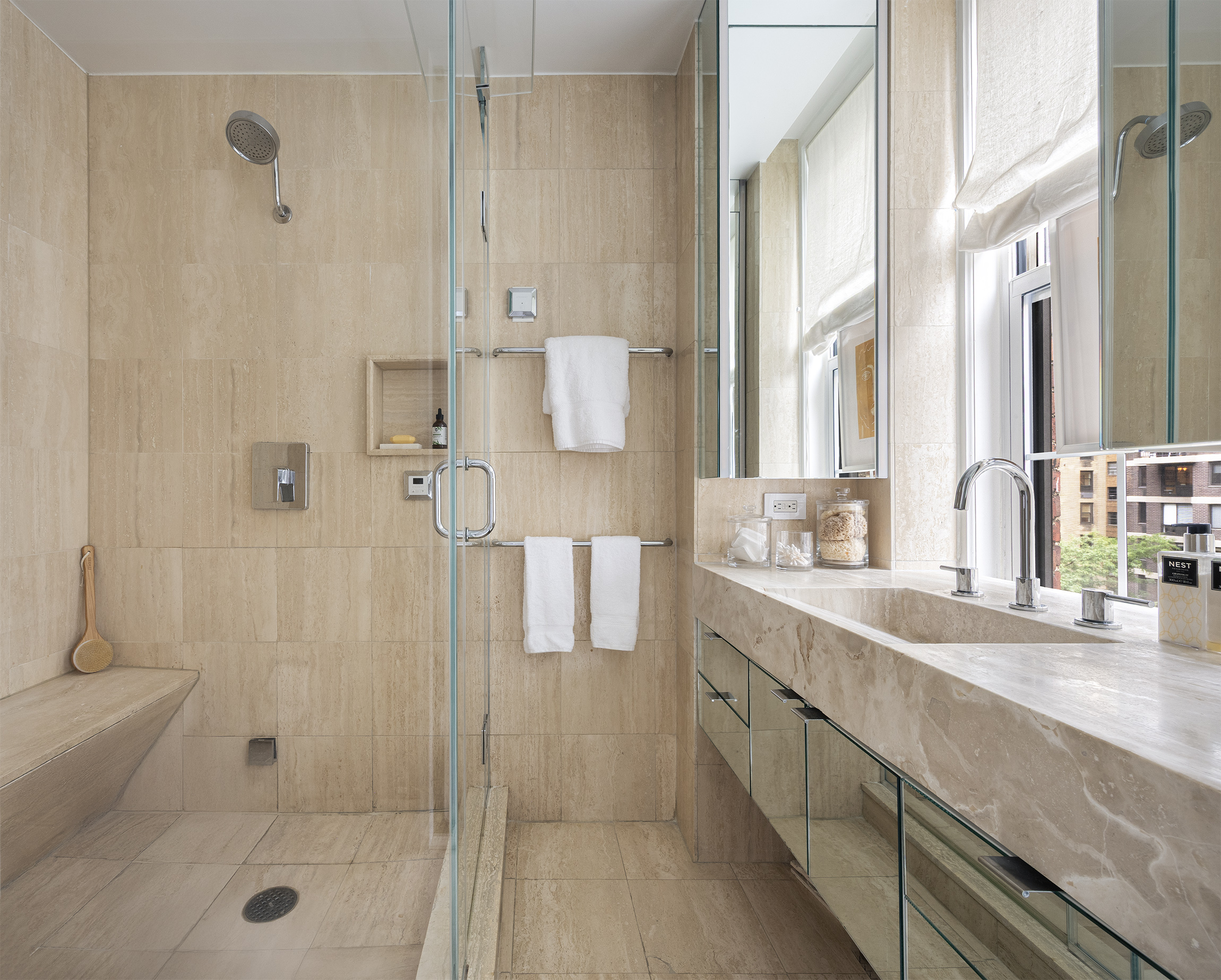 1070 Park Avenue, Unit 7D Manhattan, NY 10128 - Photo 9 of 14 a spacious bathroom with a shower sink and mirror