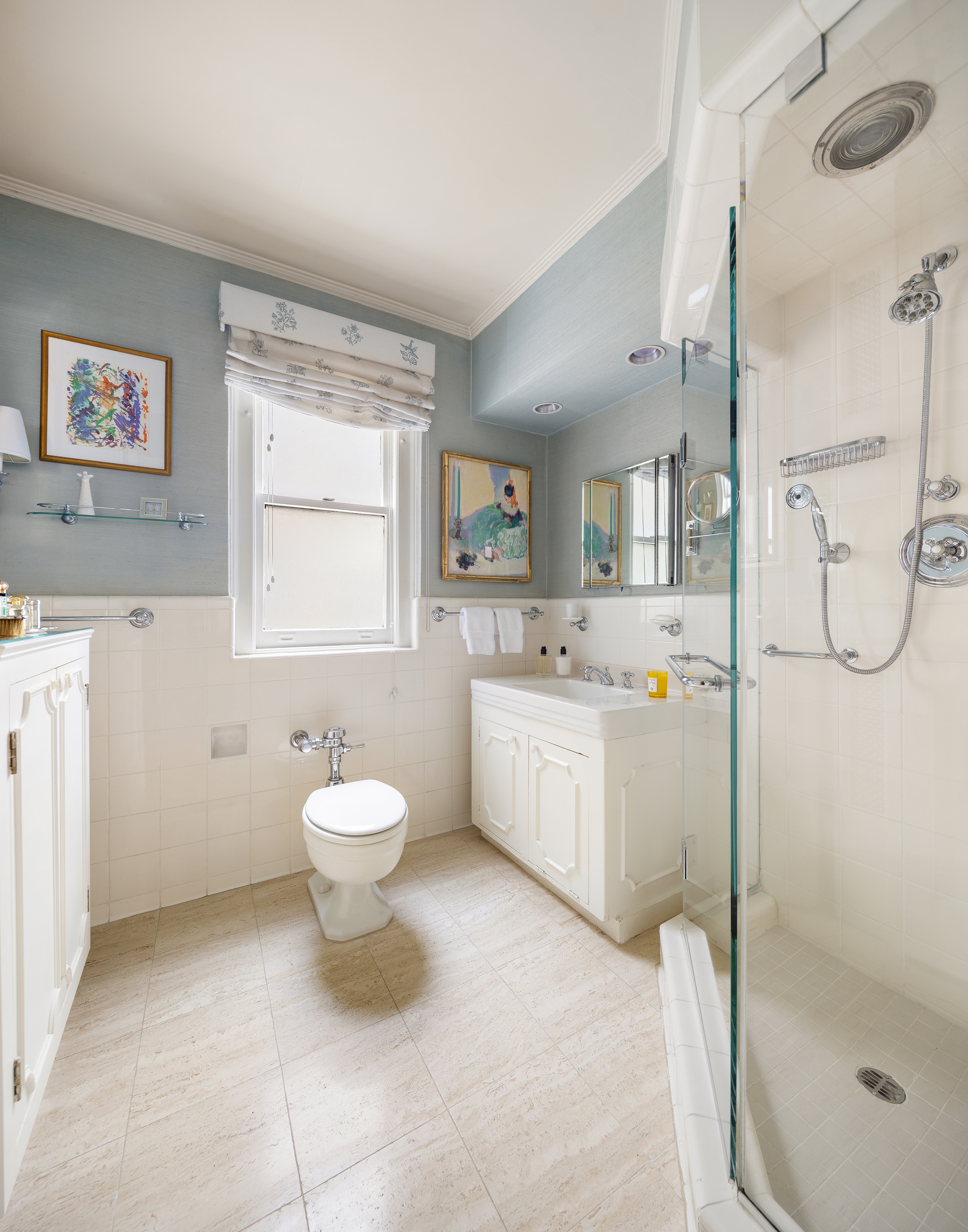 70 East 77th Street, Unit 6A Manhattan, NY 10075 - Photo 11 of 17 a bathroom with a toilet sink a mirror and a shower