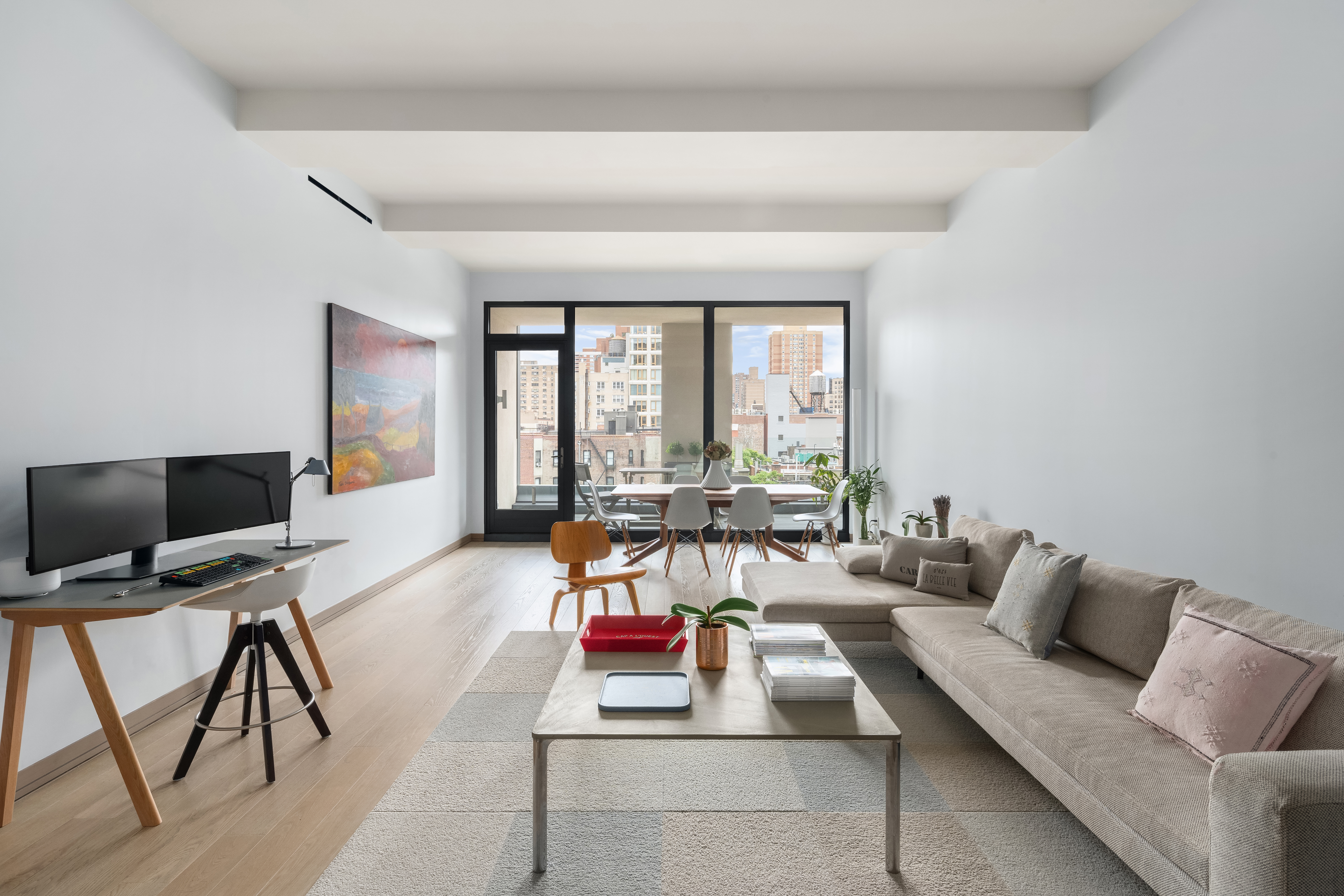 90 Lexington Avenue, Unit 8D Manhattan, NY 10016 - Photo 1 of 15 a living room with furniture and a flat screen tv