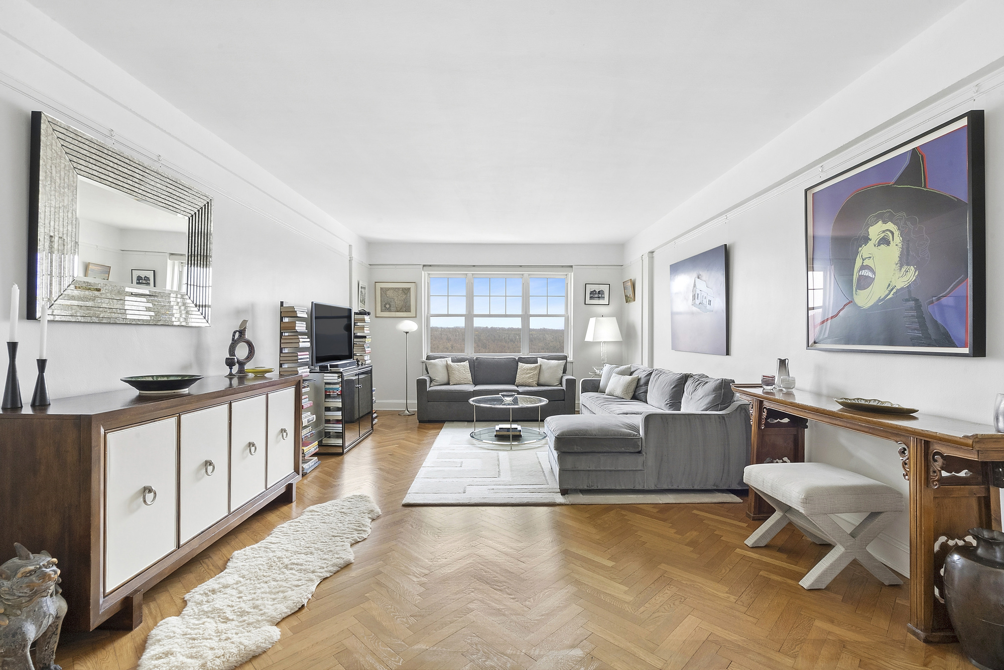 a large living room with stainless steel appliances kitchen island granite countertop furniture and a large window