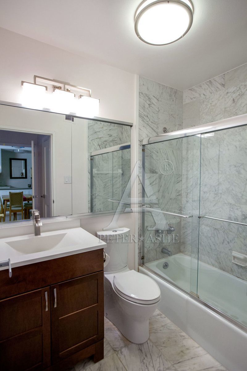 220 East 65th Street, Unit 3K Manhattan, NY 10065 - Photo 3 of 13 a bathroom with a sink a toilet and shower