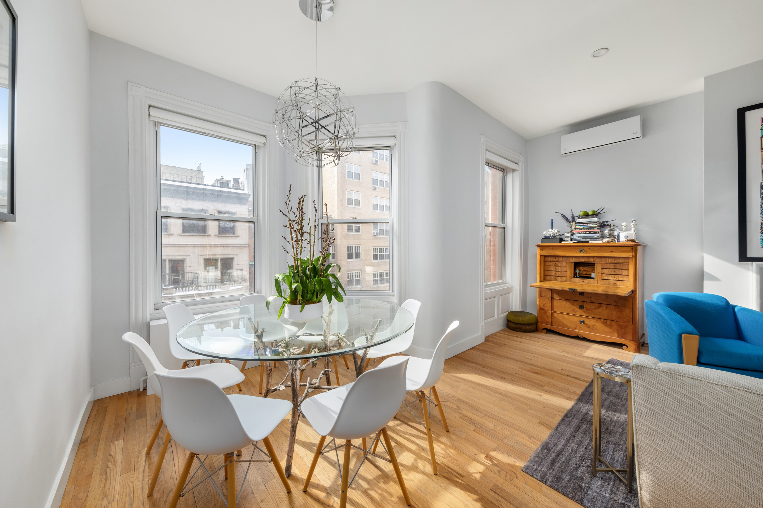 311 West 76th Street, Unit PH-5 Manhattan, NY 10023 - Photo 3 of 11 a dining room with furniture a chandelier and wooden floor