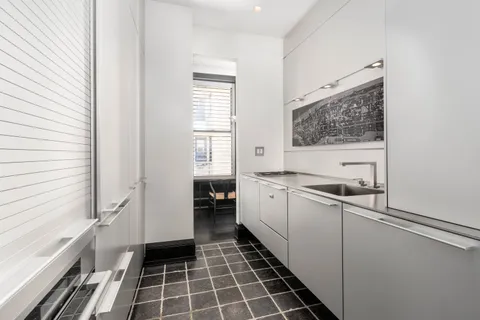 a kitchen with a sink and a refrigerator