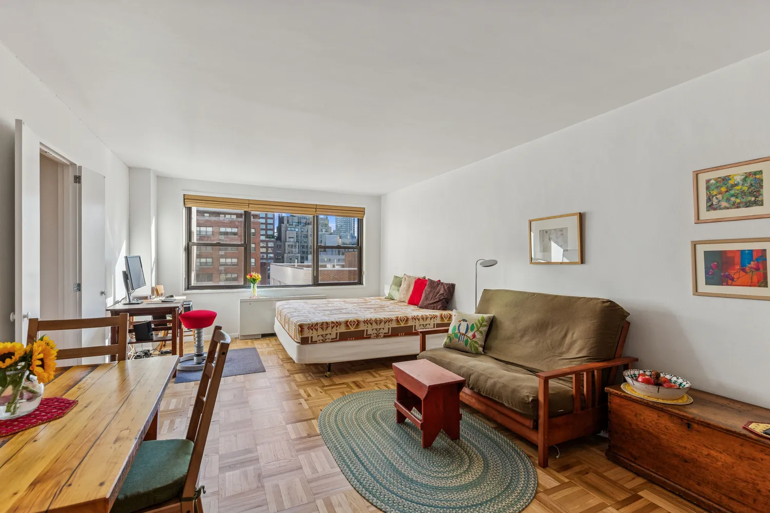 a living room with furniture a flat screen tv and a window
