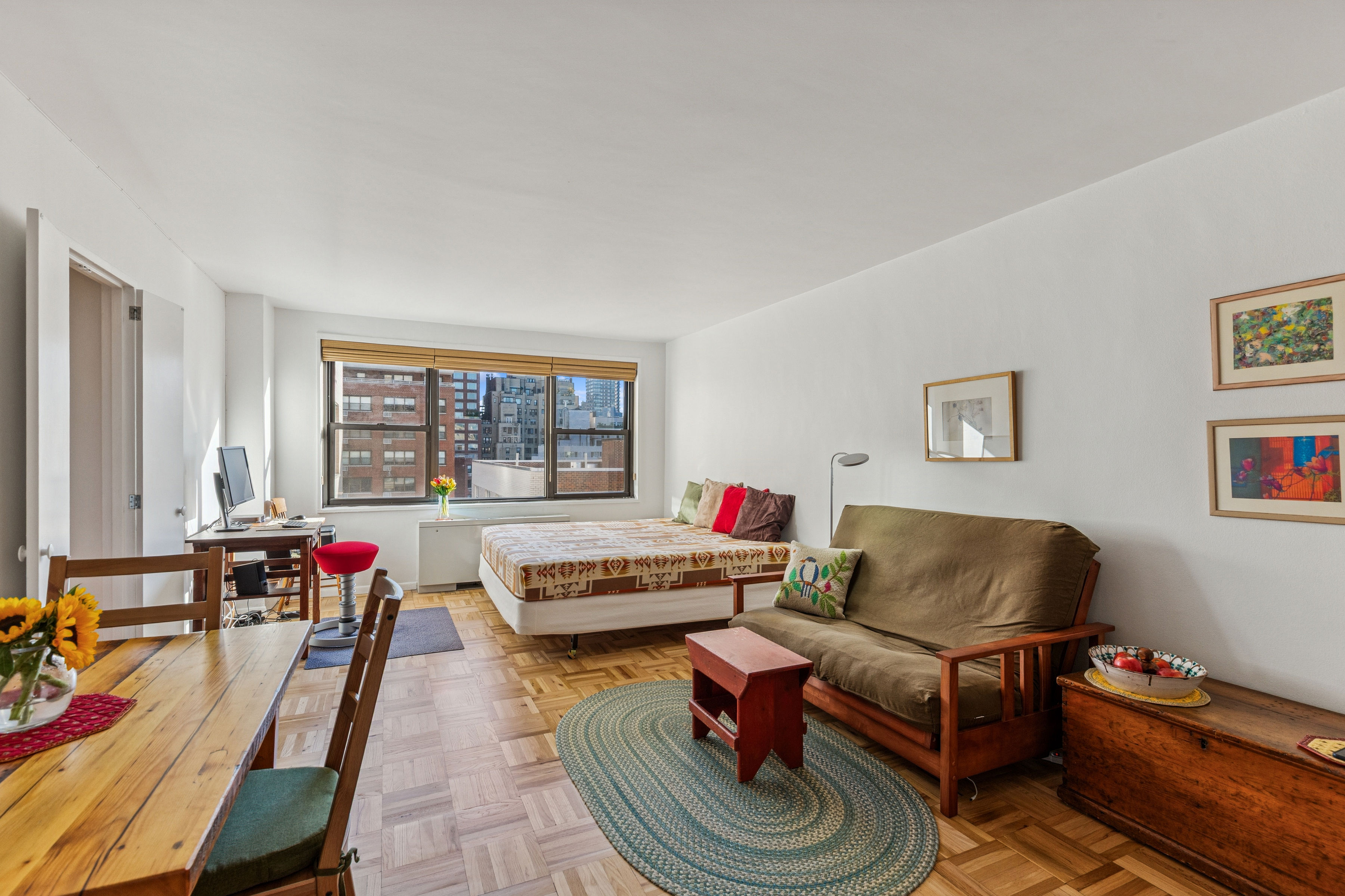 a living room with furniture a flat screen tv and a window