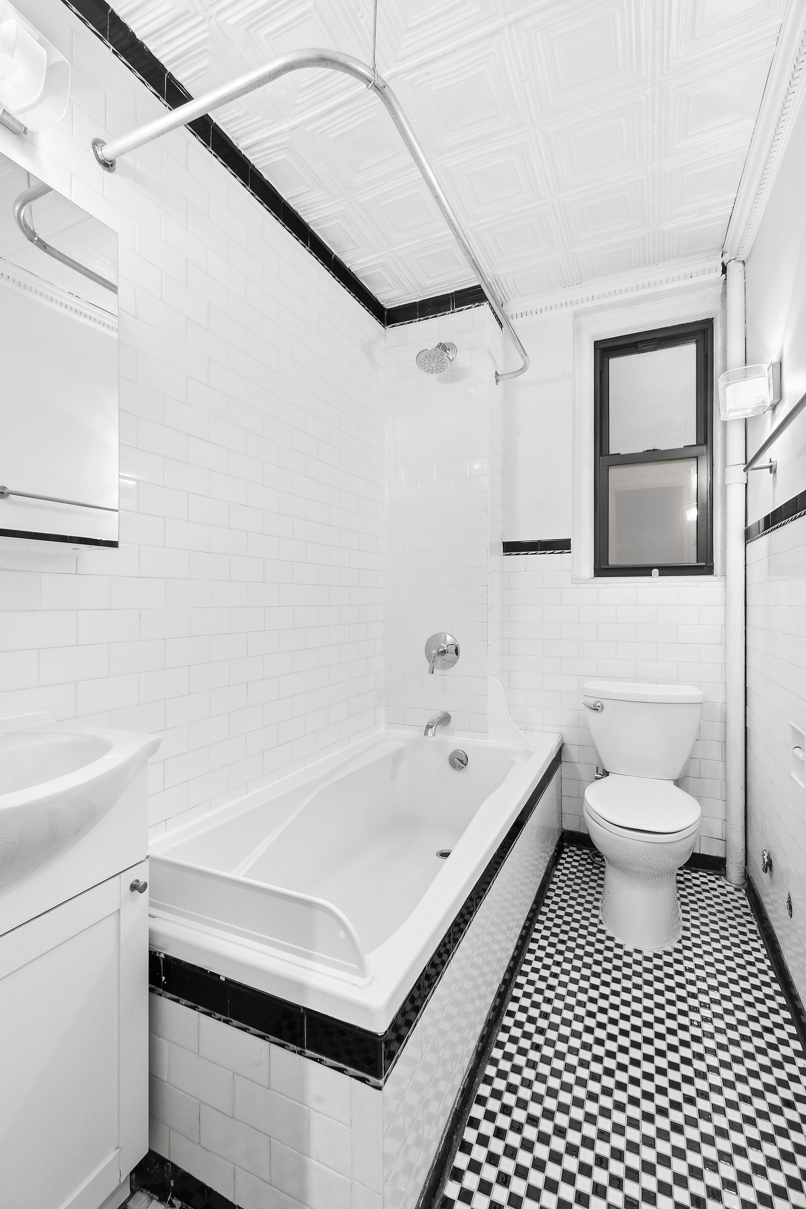 321 East 54th Street, Unit 4A Manhattan, NY 10022 - Photo 6 of 9 a bathroom with a sink a toilet and a bathtub