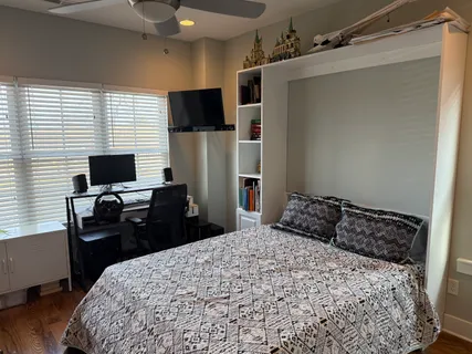 a bedroom with a bed and a flat screen tv