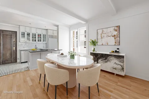 a dining room with furniture and wooden floor